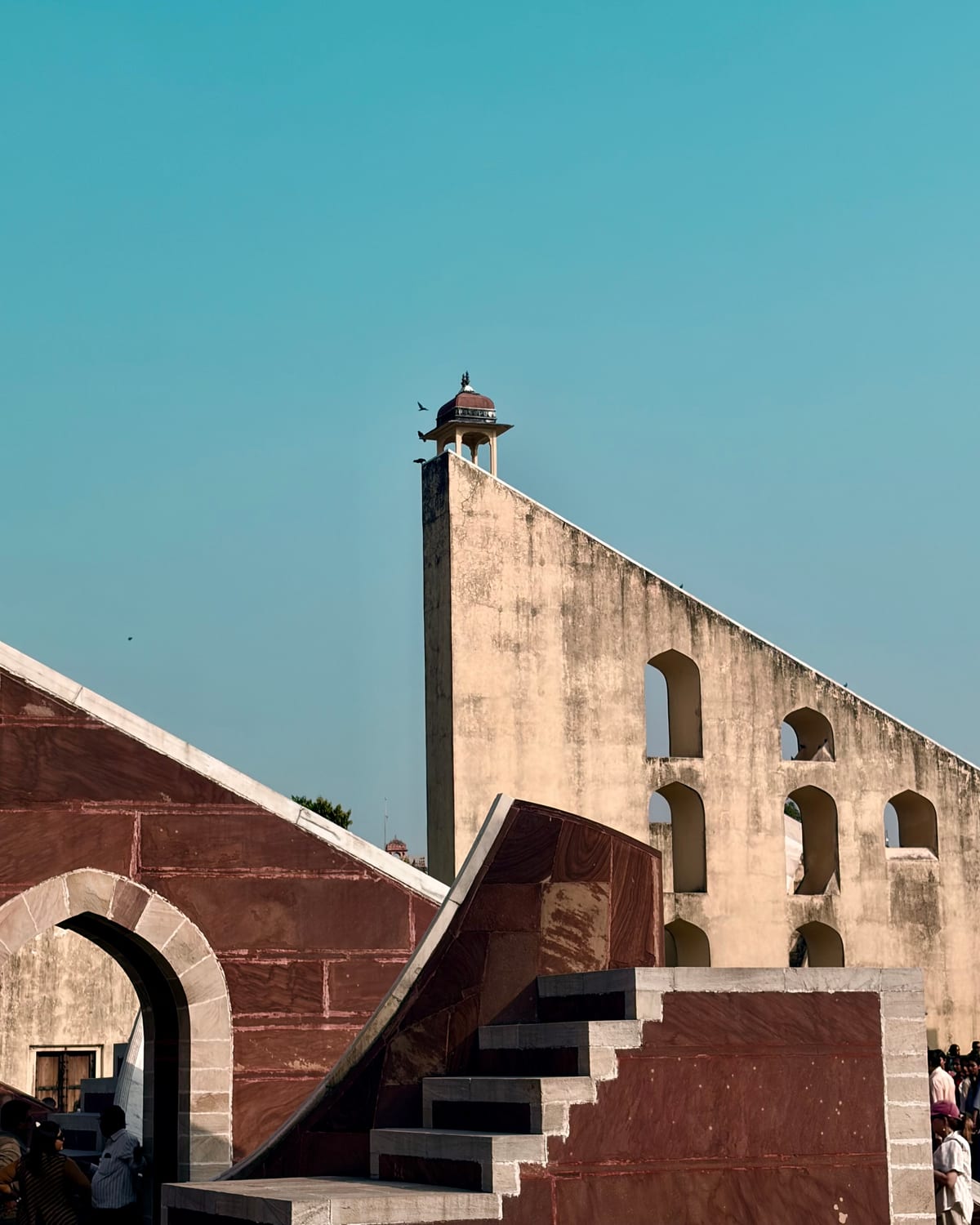 The angled stone instruments of Jantar Mantar against a clear sky