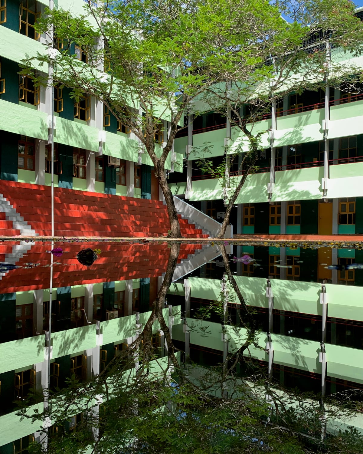 The college block mirrored in standing water after rain